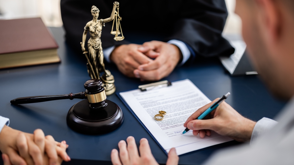Young couple consulting with a lawyer in court to sign a divorce