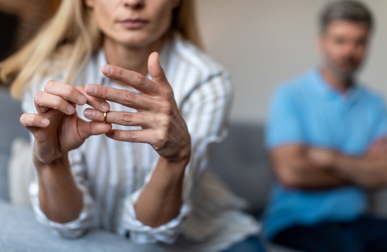 wife takes off ring, ignoring man during quarrel in living room