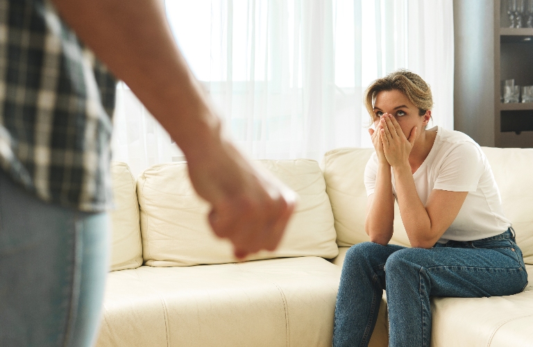 Scared woman victim of domestic violence attacked by her agressive partner