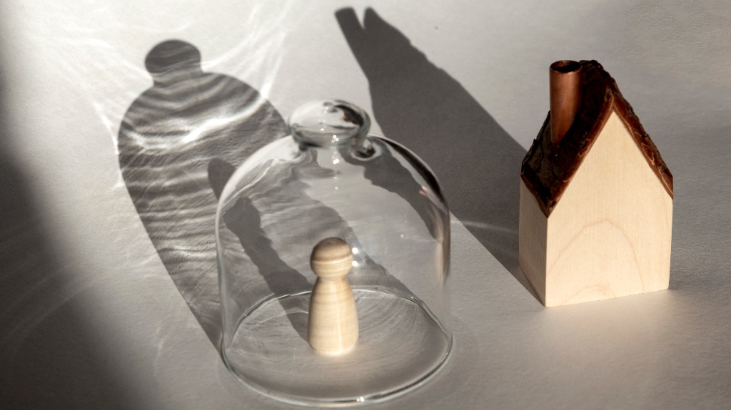 person under transparent cap isolated from house