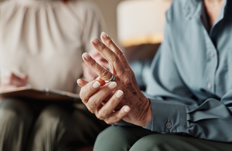 woman is touching her wedding band